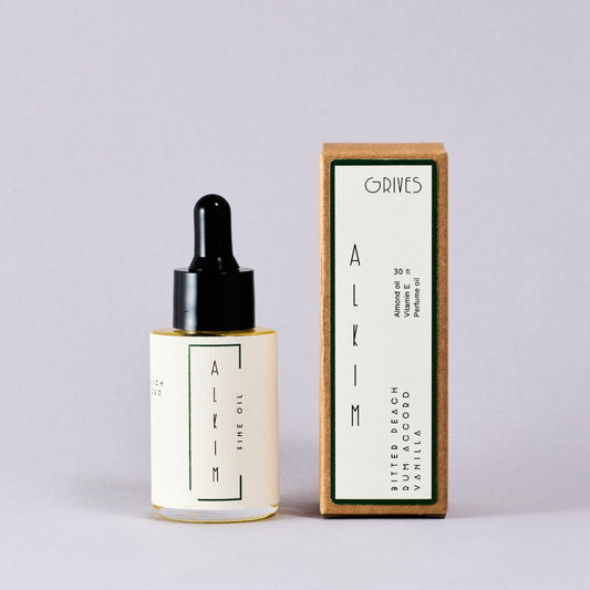 Bottle and box of Grives Alkim perfume on a light gray background