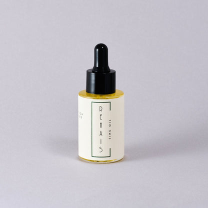 Bottle of RENAIS skincare oil with dropper on a light gray background