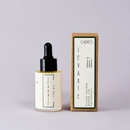 Levante perfume bottle with wooden box on a light gray background